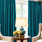 Bright yellow velvet curtains hanging in front of large window with white trim, natural light, and outdoor view, home decor