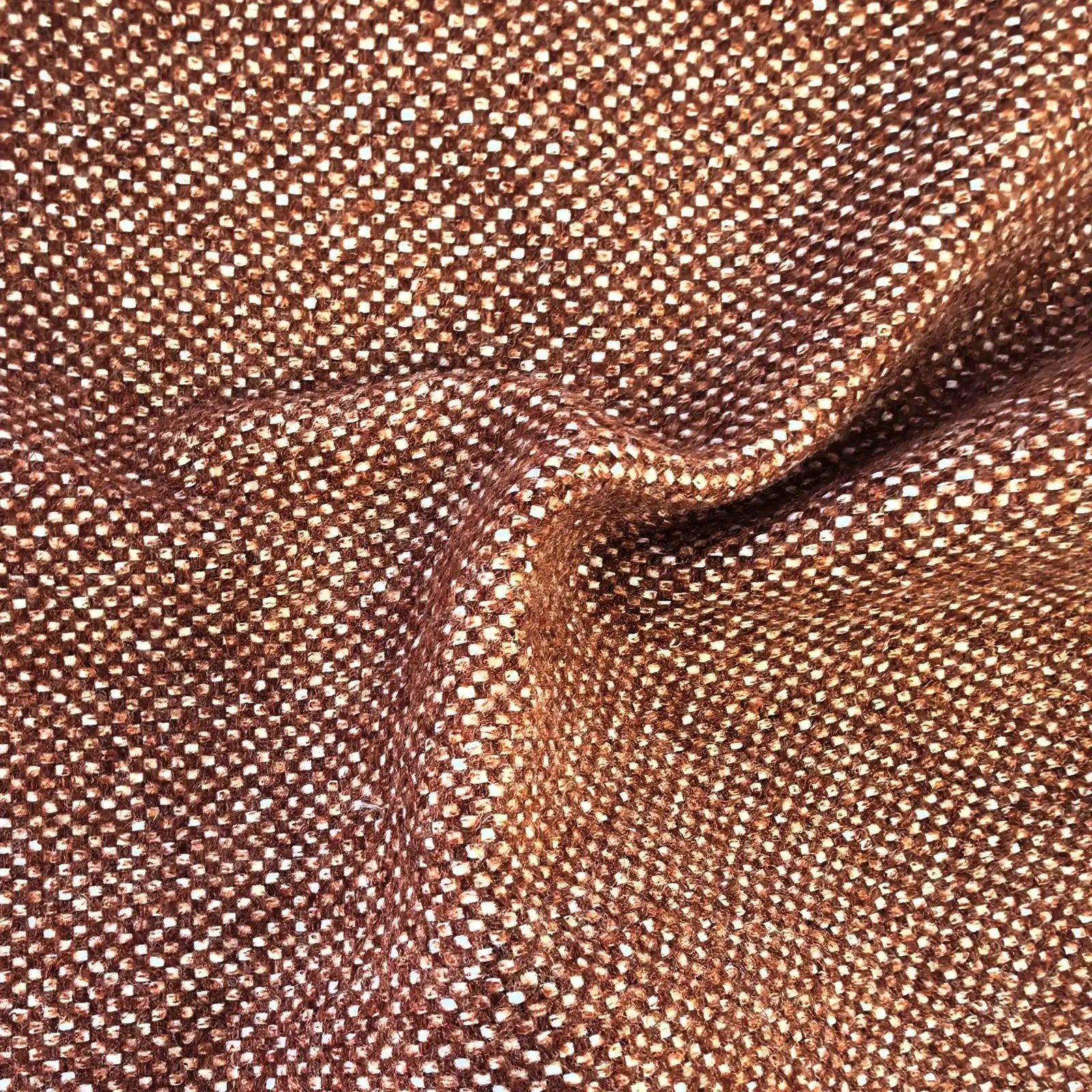A close-up texture shot of the rich caramel-brown fabric with an organic, wavy rumple near the center. The detailed basketweave pattern shows a tight grid of warm coppery-brown and contrasting white threads.