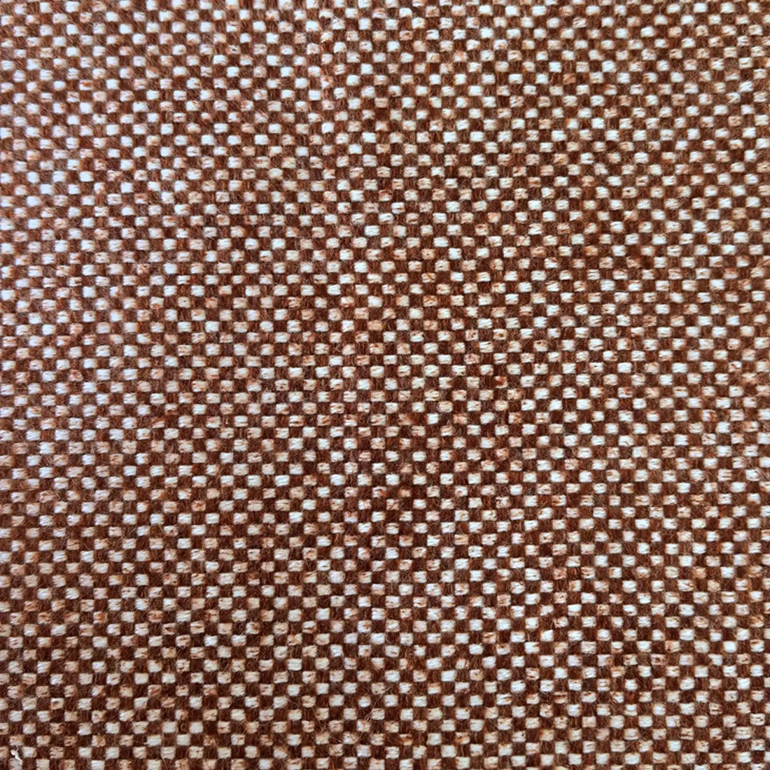 A flat, straight-on full-frame macro view showing the tight, uniform basketweave structure of the fabric, characterized by an even, repeating grid of white and rich caramel yarns.