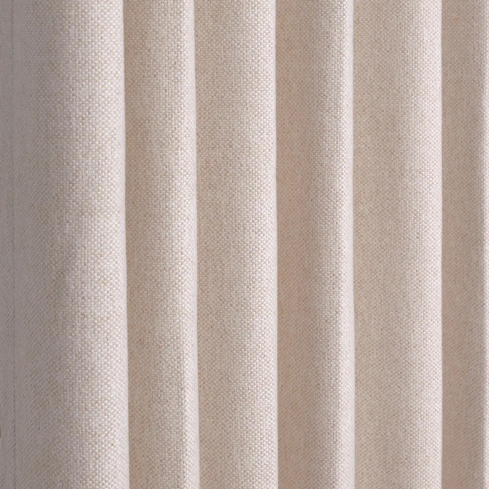 A full-frame close-up showing the precise, structured vertical pleats of the hanging light yellow curtain, highlighting its uniform drape and woven linen-style texture.