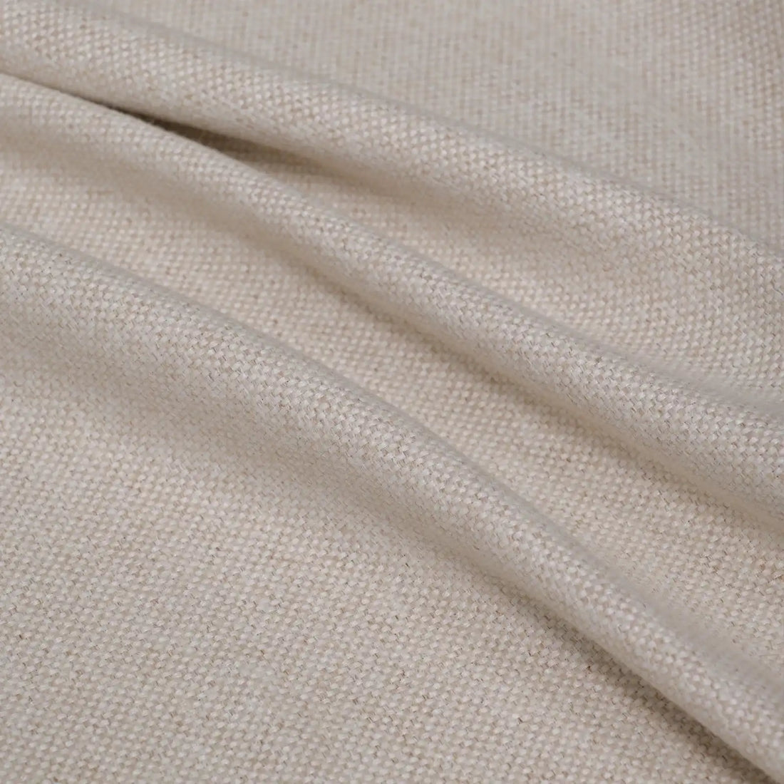 A soft, full-frame shot of the light yellow curtain material arranged in fluid diagonal folds, showcasing its rich tactile quality and light-catching weave.