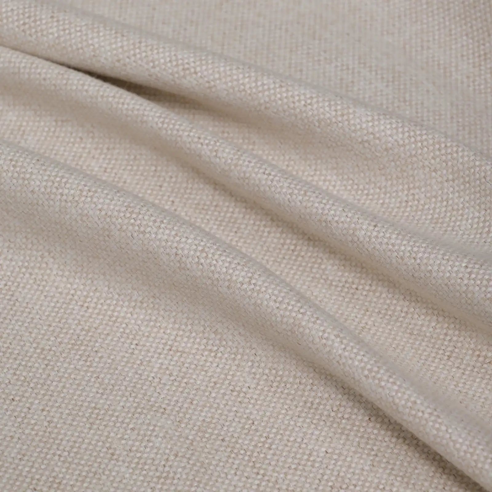 A soft, full-frame shot of the light yellow curtain material arranged in fluid diagonal folds, showcasing its rich tactile quality and light-catching weave.