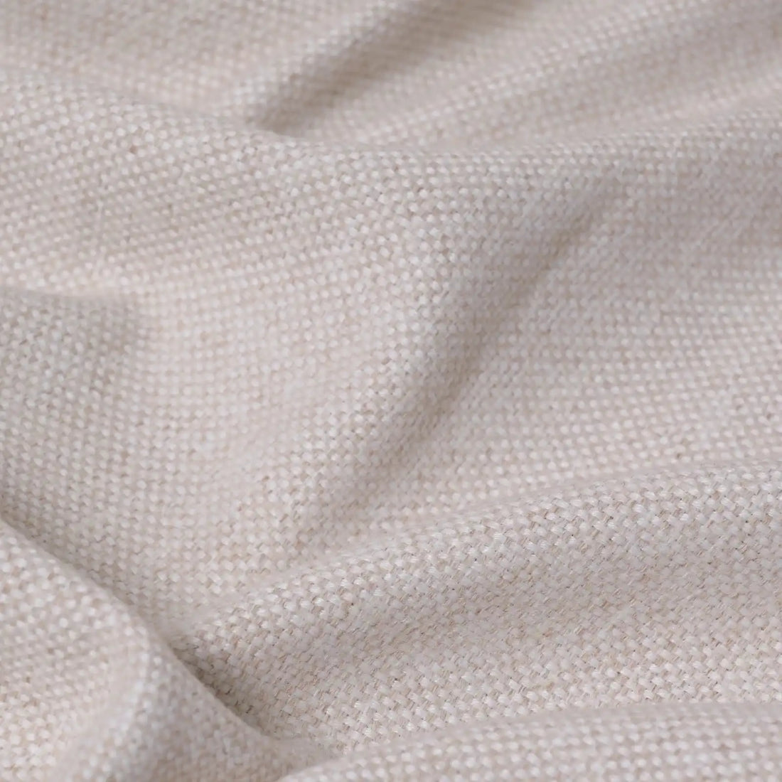 A close-up texture shot of the light yellow fabric cascading in soft, organic ripples, emphasizing its heavy weight and subtle multi-tone slub yarn details.