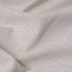 A close-up texture shot of the light yellow fabric cascading in soft, organic ripples, emphasizing its heavy weight and subtle multi-tone slub yarn details.