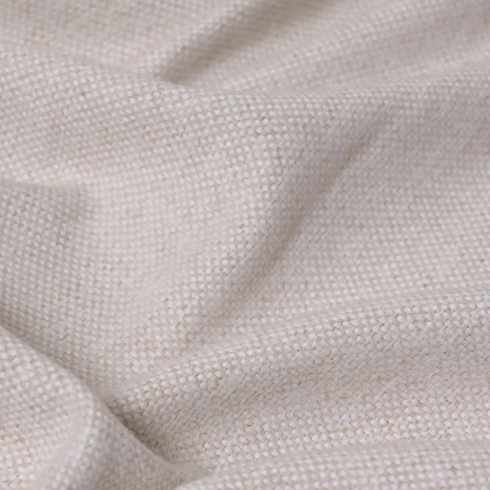 A close-up texture shot of the light yellow fabric cascading in soft, organic ripples, emphasizing its heavy weight and subtle multi-tone slub yarn details.