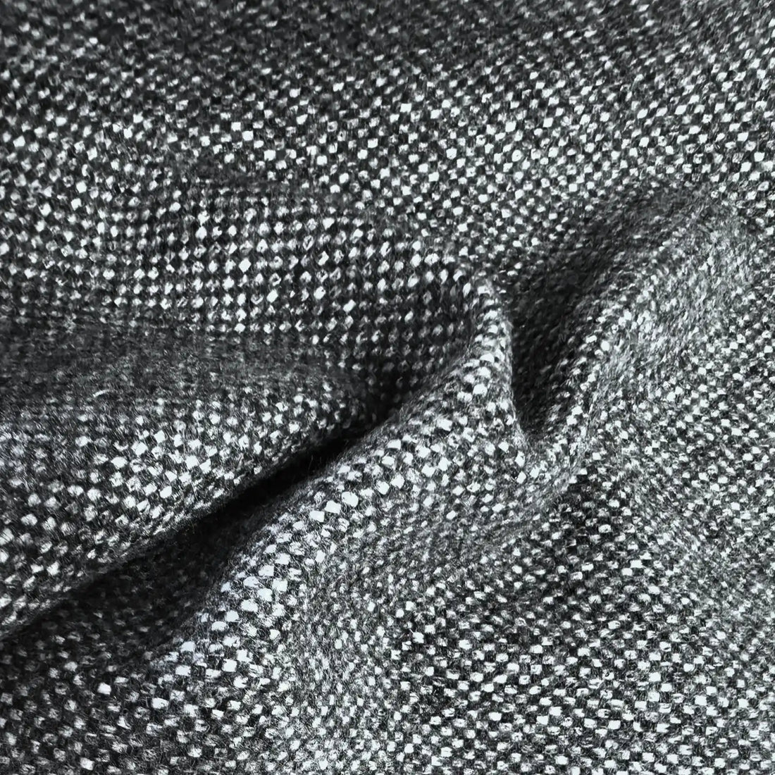 A flat, full-frame macro shot highlighting the uniform and tight basketweave pattern of the curtain fabric, composed of a precise, repeating grid of charcoal gray and white yarns.