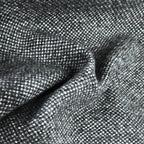 A flat, full-frame macro shot highlighting the uniform and tight basketweave pattern of the curtain fabric, composed of a precise, repeating grid of charcoal gray and white yarns.