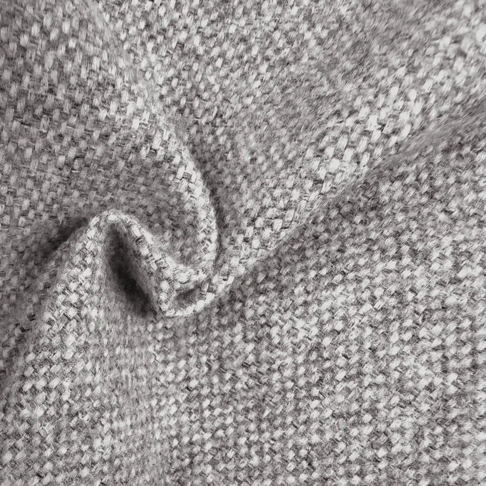 A close-up view of the gray textured fabric gathered into a soft, wavy ripple, showcasing the interlaced gray and white threads and the heavy, natural drape of the material.