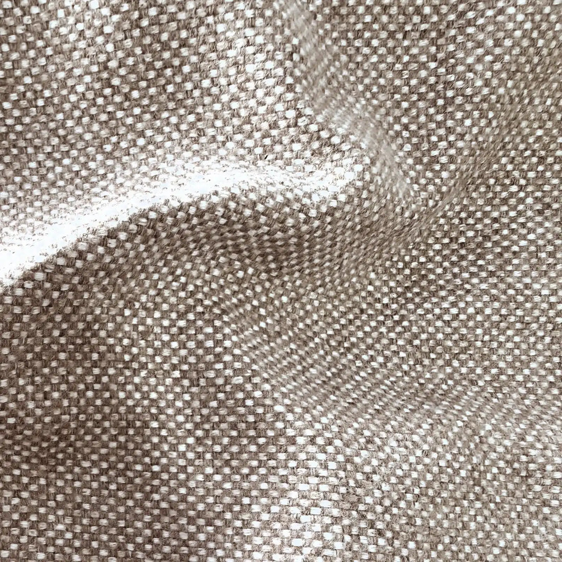 A tactile texture shot of the woven fabric arranged in fluid, cascading diagonal folds that showcase its soft luster and rich, linen-like quality.