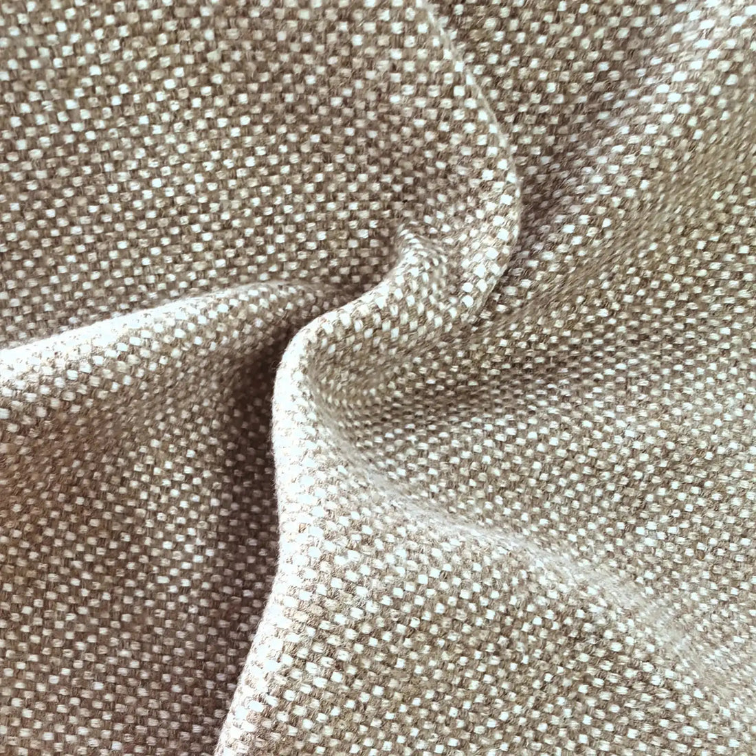 A close-up view of the grayish-brown textile gathered into soft, organic ripples, highlighting the heavy drape, light-catching weave, and multi-tonal yarn details.