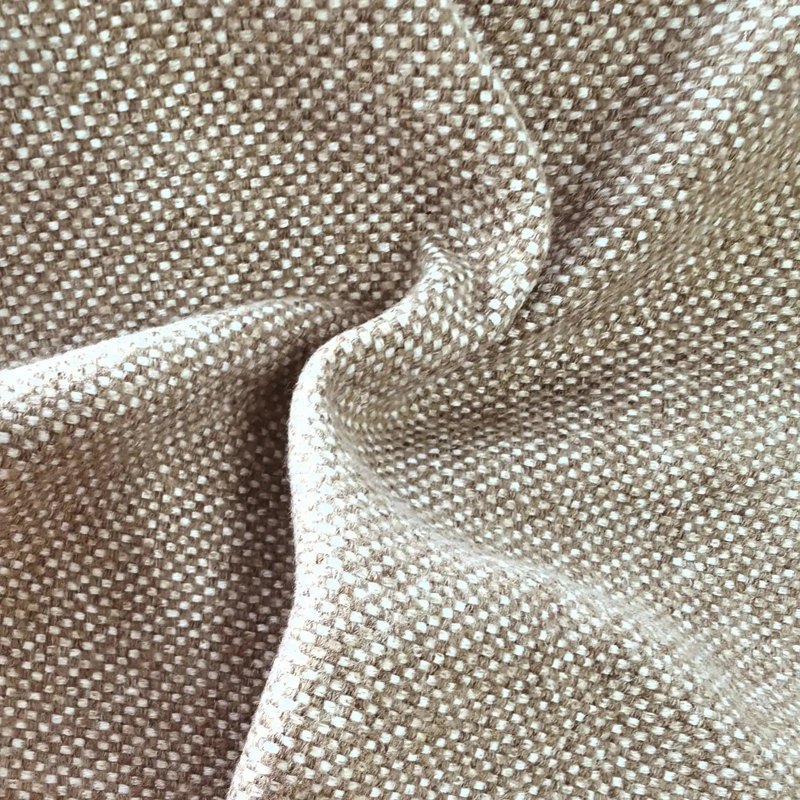 A close-up view of the grayish-brown textile gathered into soft, organic ripples, highlighting the heavy drape, light-catching weave, and multi-tonal yarn details.