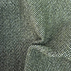 A tactile texture shot of the deep green fabric gathered into heavy, organic folds and ripples, highlighting the material's premium thickness, natural drape, and multi-tonal woven quality.