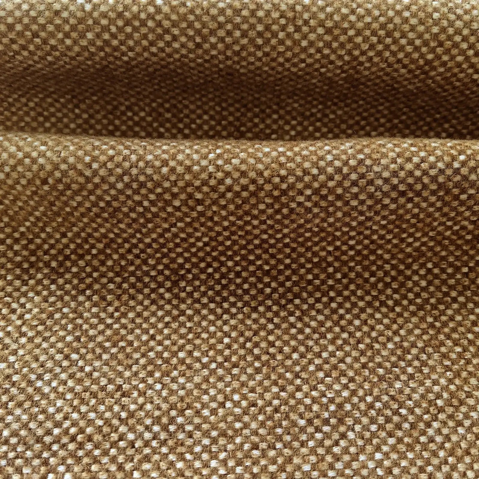 A detailed close-up shot of the light brown woven fabric folded horizontally, showcasing its thick, tactile texture and clean, well-defined weave.