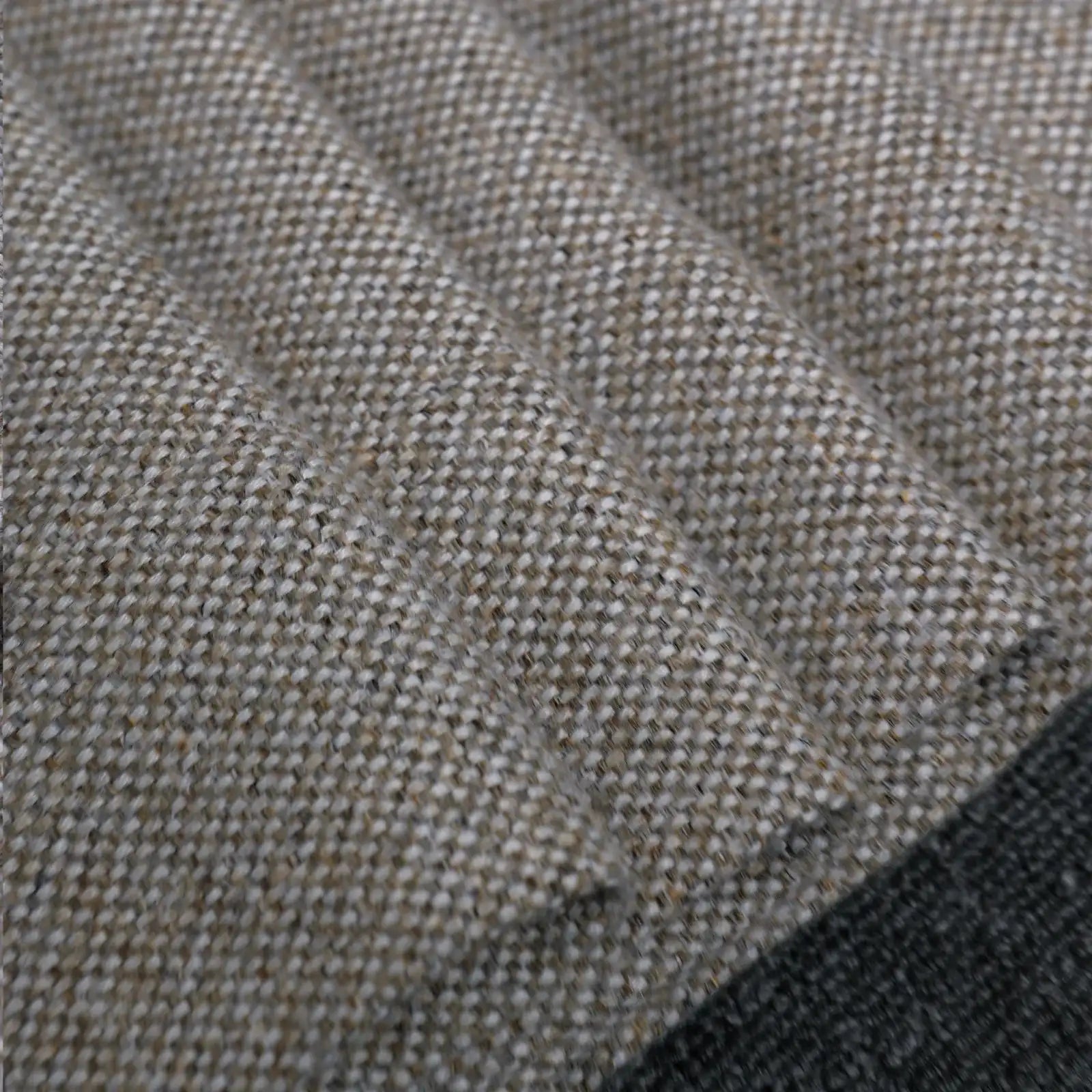 A close-up texture shot of the light gray heathered fabric arranged in tight, soft folds, emphasizing the weight, quality, and detailed yarn structure of the material.