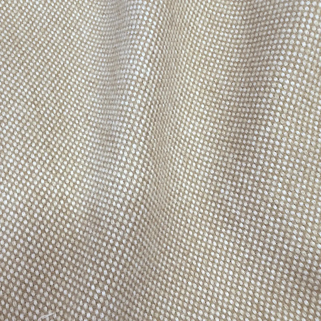 A close-up texture shot of the light yellow-tan woven fabric draped in smooth, diagonal waves, showcasing the material's soft luster, clean drape, and consistent basketweave pattern.