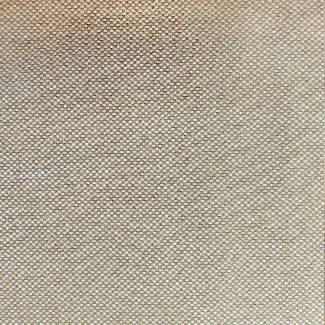 A close-up shot focusing on a light yellow-tan curtain panel hanging in crisp, neat vertical pleats. The fabric's subtle textured pattern is highlighted against a bright white window frame in the background.