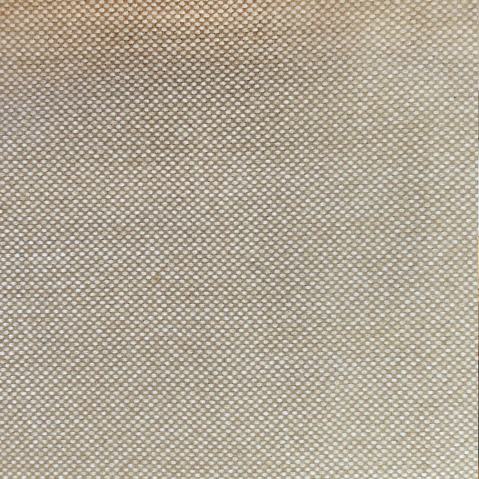 A close-up shot focusing on a light yellow-tan curtain panel hanging in crisp, neat vertical pleats. The fabric's subtle textured pattern is highlighted against a bright white window frame in the background.