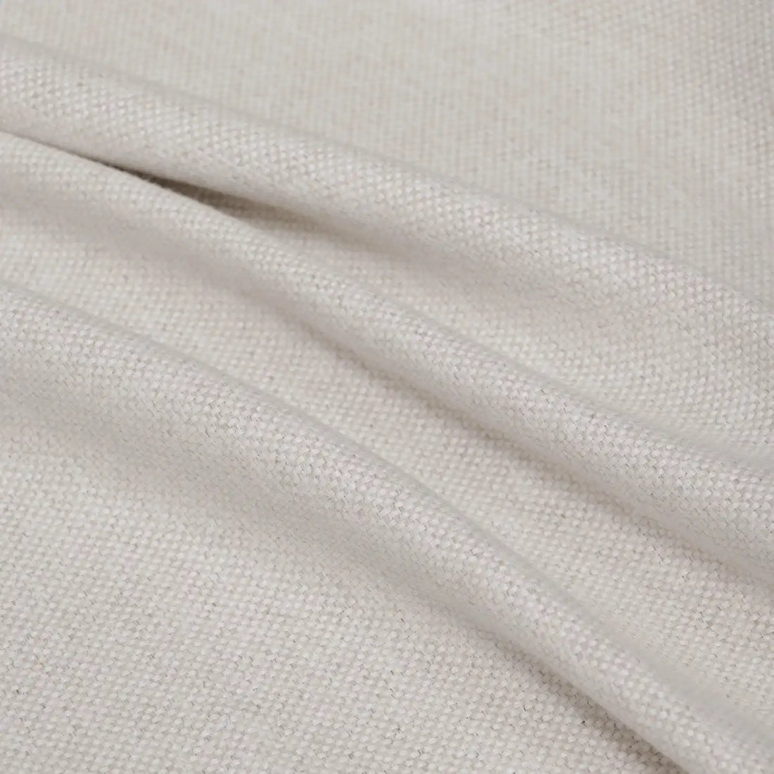 A soft, full-frame shot of the light yellow curtain material arranged in fluid diagonal folds, showcasing its rich tactile quality and light-catching weave.