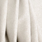 A close-up view of the off-white curtain material arranged in soft, heavy vertical folds, emphasizing its thick fabrication and subtle cream undertones.