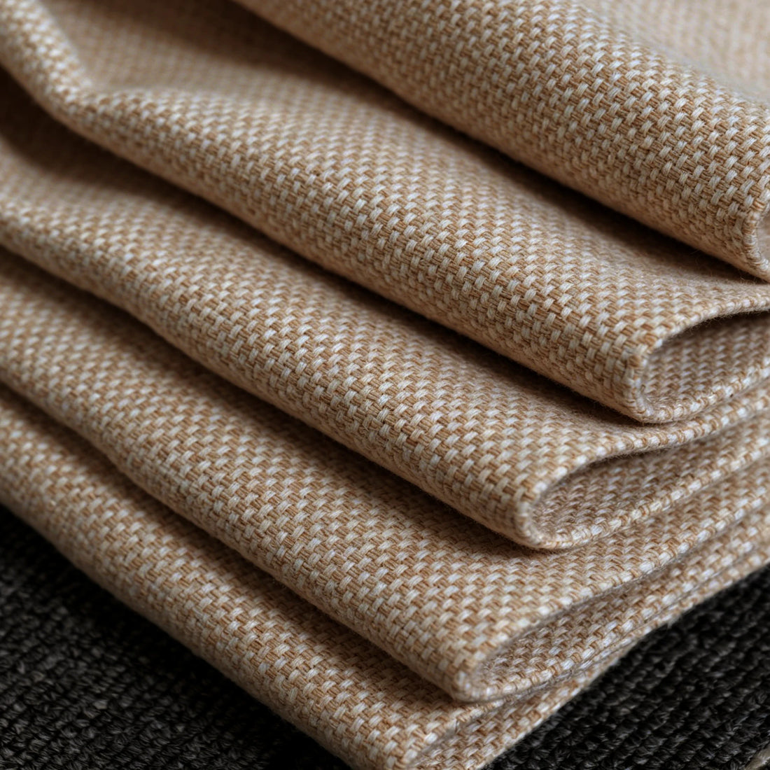 A detailed close-up shot of the yellow and white woven curtain fabric neatly folded in layers, highlighting the thick texture and clean edges of the material.