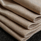 A detailed close-up shot of the yellow and white woven curtain fabric neatly folded in layers, highlighting the thick texture and clean edges of the material.