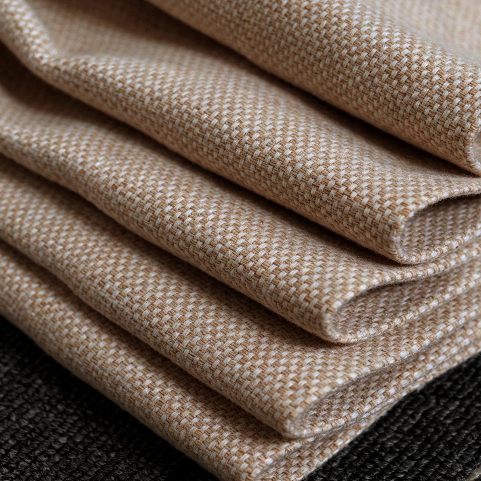 A detailed close-up shot of the yellow and white woven curtain fabric neatly folded in layers, highlighting the thick texture and clean edges of the material.