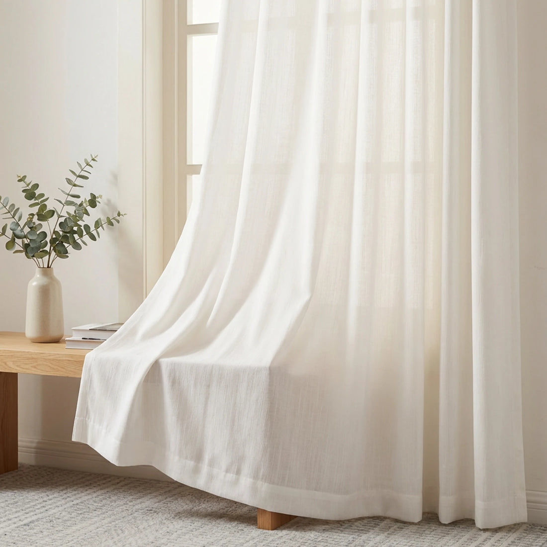Soft light filtering White Sarah Semi Sheer Curtains draping elegantly over a wooden bench