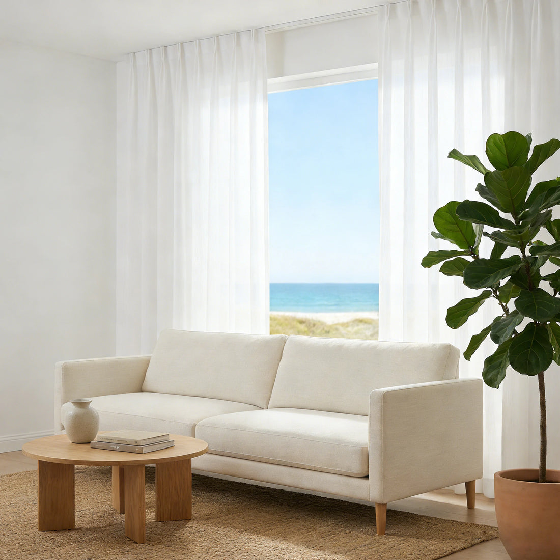 Coastal living room with breezy White Sarah Semi Sheer Curtains revealing a beautiful ocean view