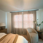 Light Brown John Linen Texture Cotton Curtains closed to filter sunlight in a minimalist neutral space