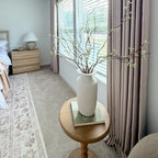 Decorative white vase on a rustic table set against the luxury drape of Light Brown John Linen Texture Cotton Curtains