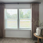 Light Brown John Linen Texture Cotton Curtains styled around white blinds with a ceramic vase on a side table