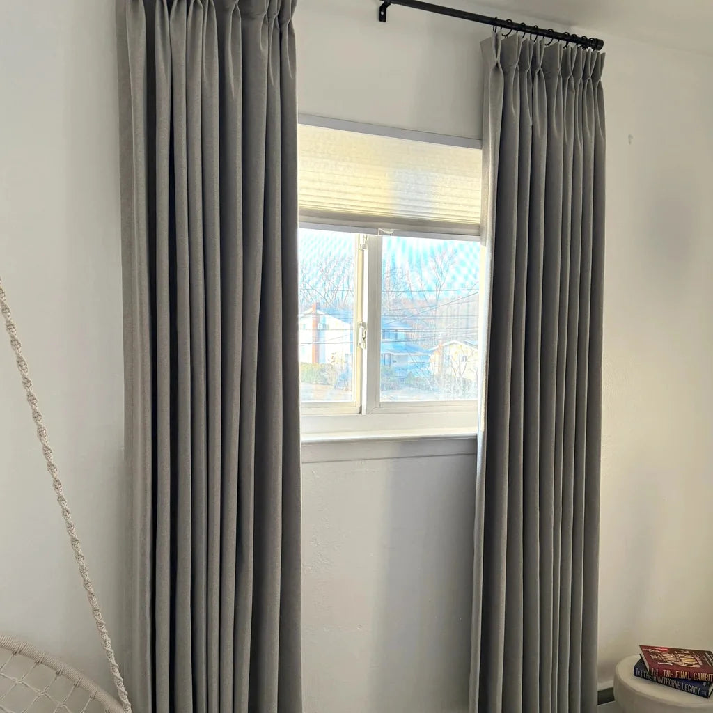 Elegant Natural Beige Orion Linen Look Blackout Curtains hanging on a black metal rod