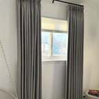 Elegant Natural Beige Orion Linen Look Blackout Curtains hanging on a black metal rod