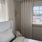 Corner view of Plaid White Jasper Dotted Linen Blend Curtains, minimalist bedroom styling with woven wall lamp