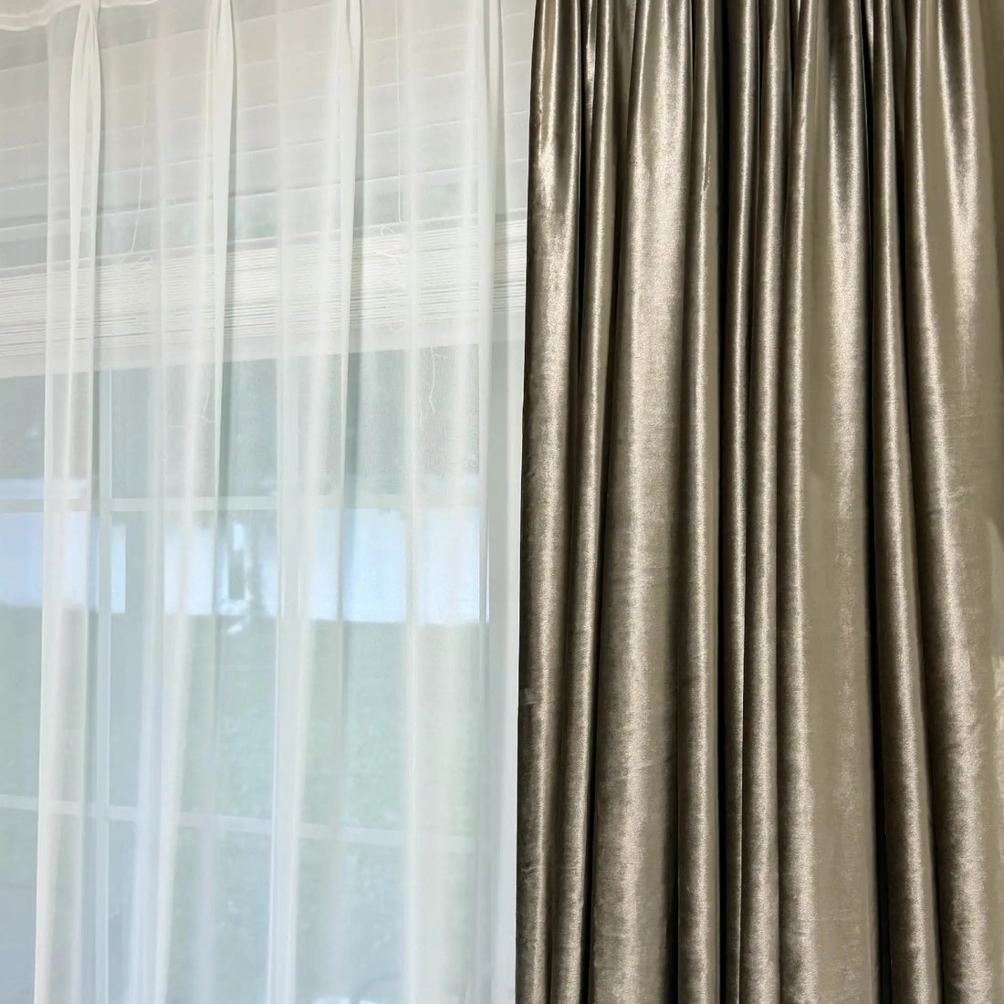 Living room window with beige velvet curtains and sheer white drapes, sunlight filtering through, contemporary home decor