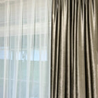 Living room window with beige velvet curtains and sheer white drapes, sunlight filtering through, contemporary home decor