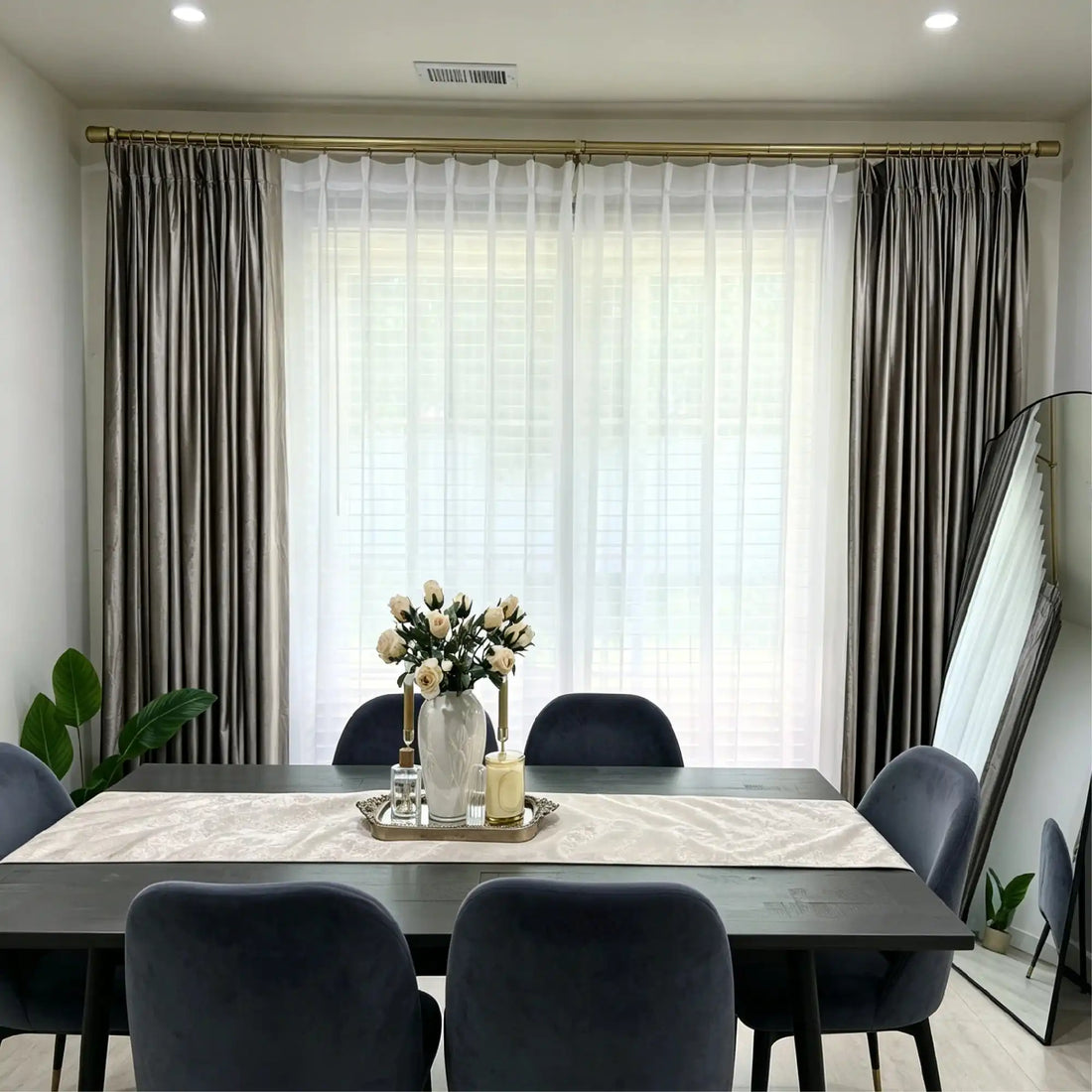 Elegant living room window with beige velvet curtains and sheer white drapes, gold curtain rod, natural light, modern decor