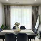 Elegant living room window with beige velvet curtains and sheer white drapes, gold curtain rod, natural light, modern decor