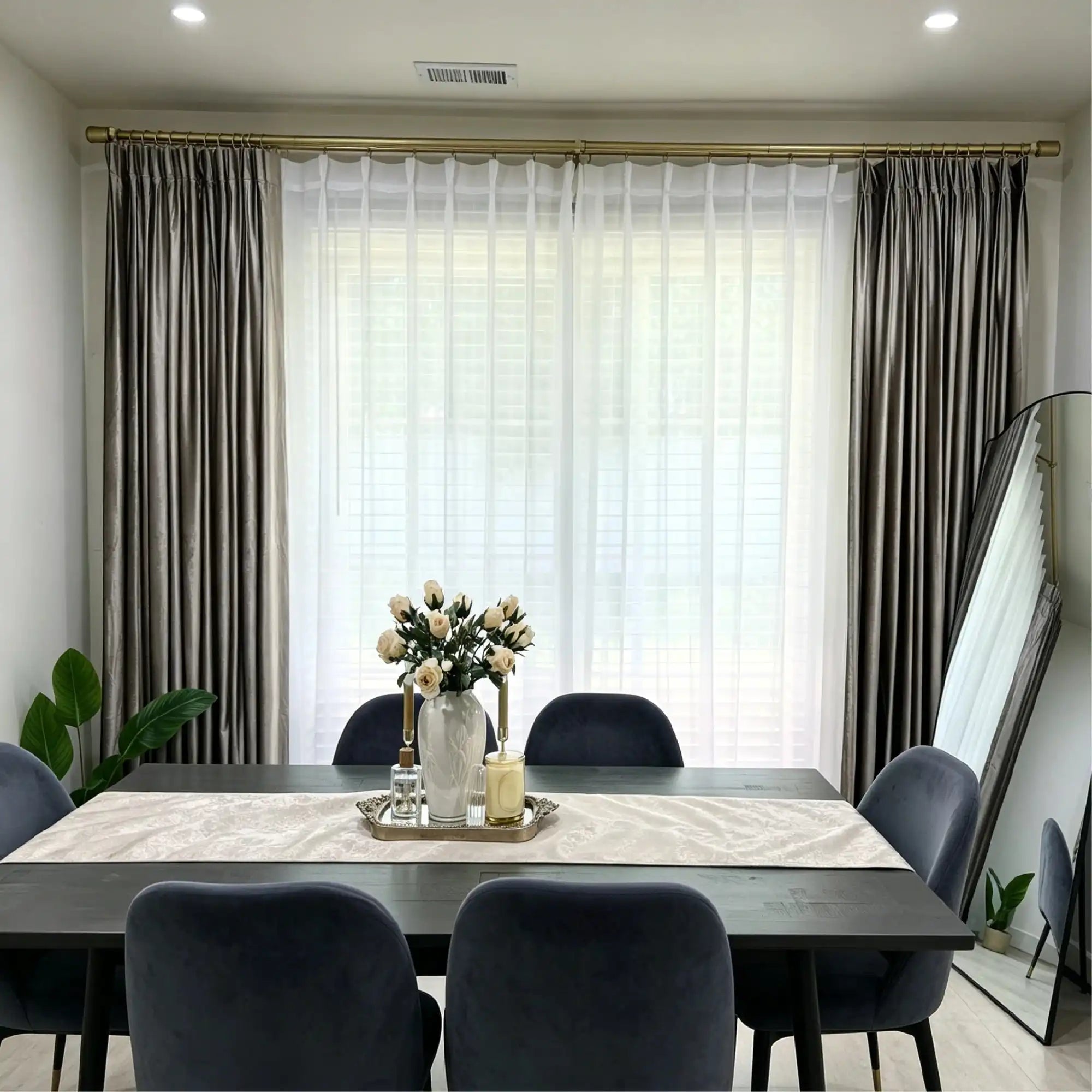 Elegant living room window with beige velvet curtains and sheer white drapes, gold curtain rod, natural light, modern decor