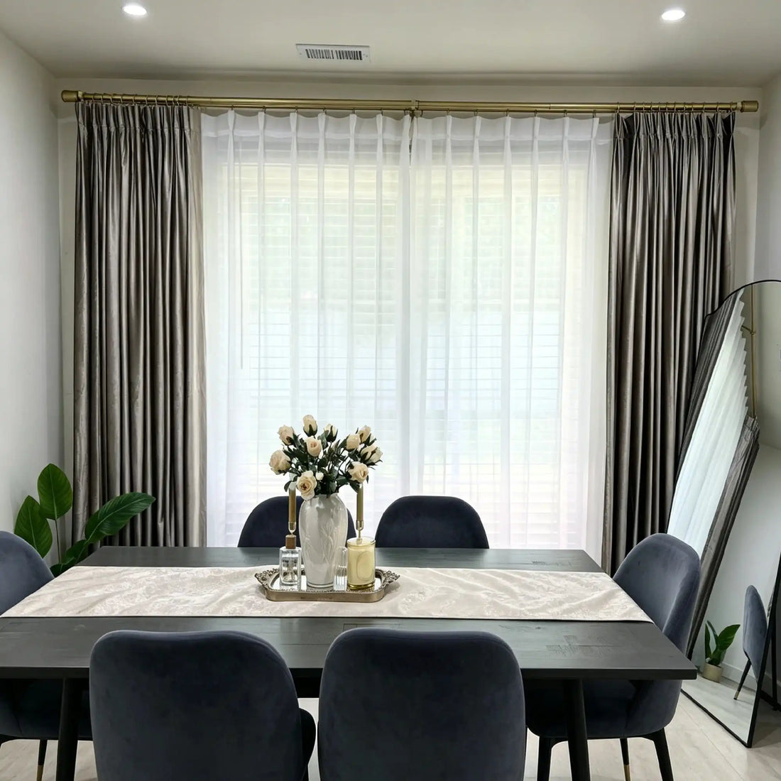 Interior view of window with beige velvet curtains and sheer white curtains, natural light, modern living space