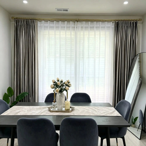 Interior view of window with beige velvet curtains and sheer white curtains, natural light, modern living space