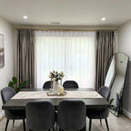 Beautifully pleated White Lisa Semi Sheer Curtains filtering soft light behind an elegant dinner table setup