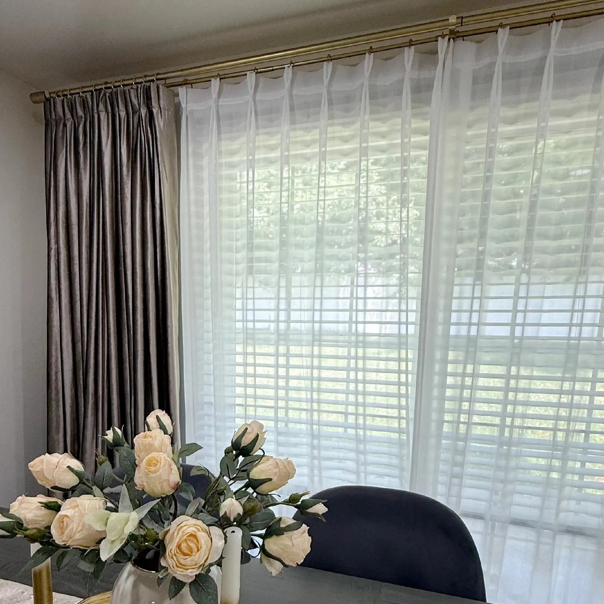 Pinch pleat White Lisa Semi Sheer Curtains layered with heavy satin drapes on a gold rod